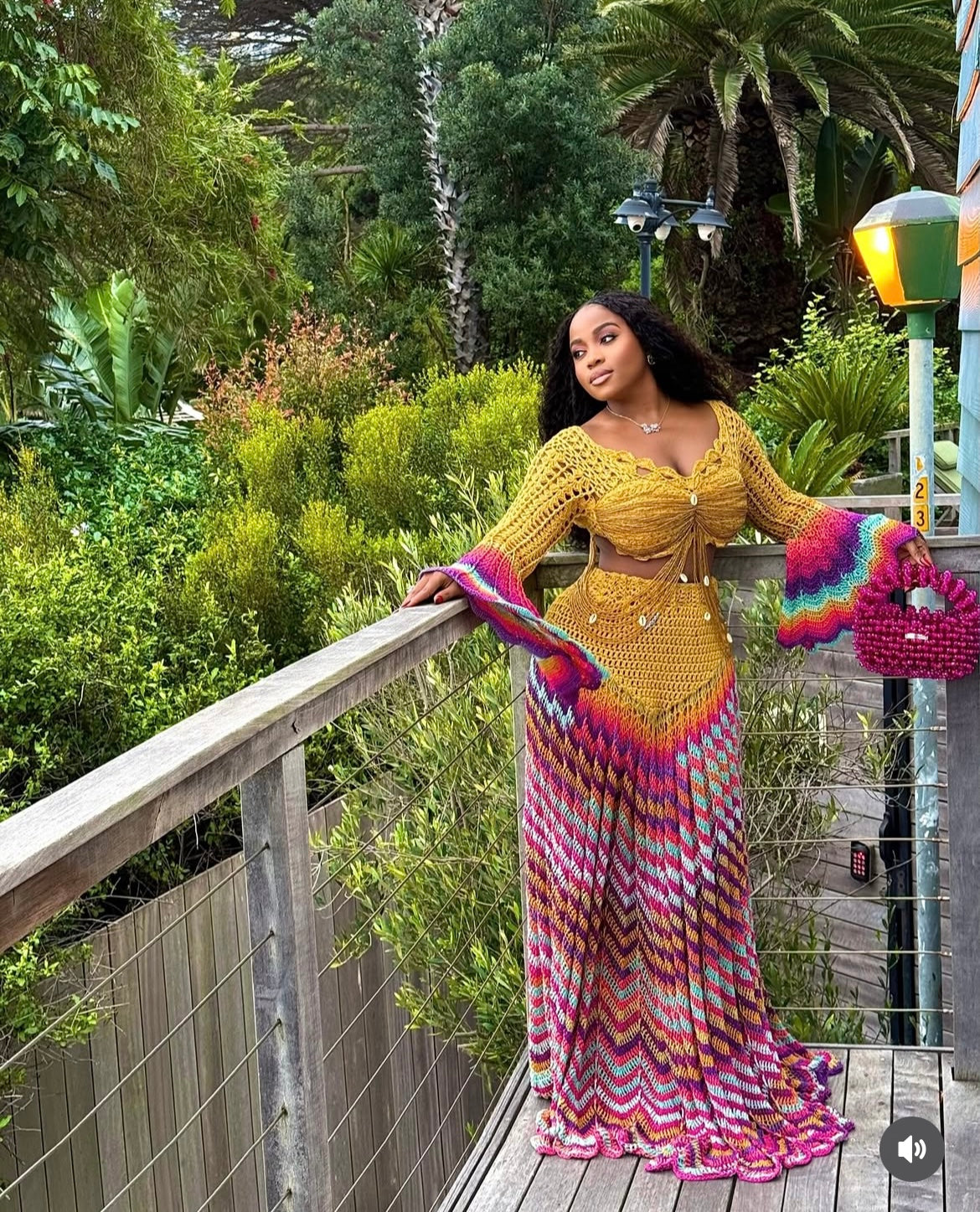 veekee james wearing hookedbylade crochet outfit in yellow and rainbow mix maxi standing