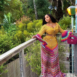 veekee james wearing hookedbylade crochet outfit in yellow and rainbow mix maxi standing